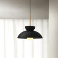 Black dome pendant from Clérachic lit with a round opal bulb, hung in front of floor-length white curtains.