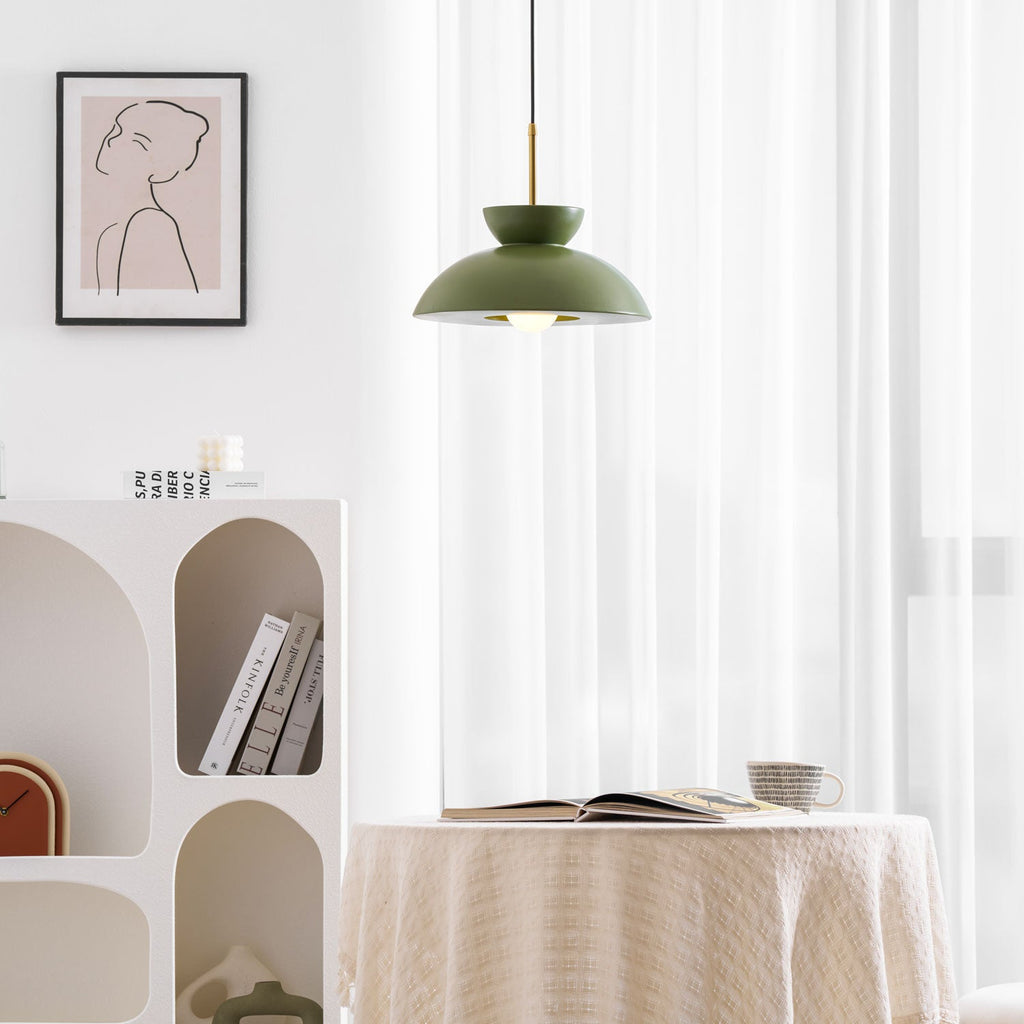 Green dome pendant from Clérachic in front of white curtains, near an arched white shelf and a framed line drawing.