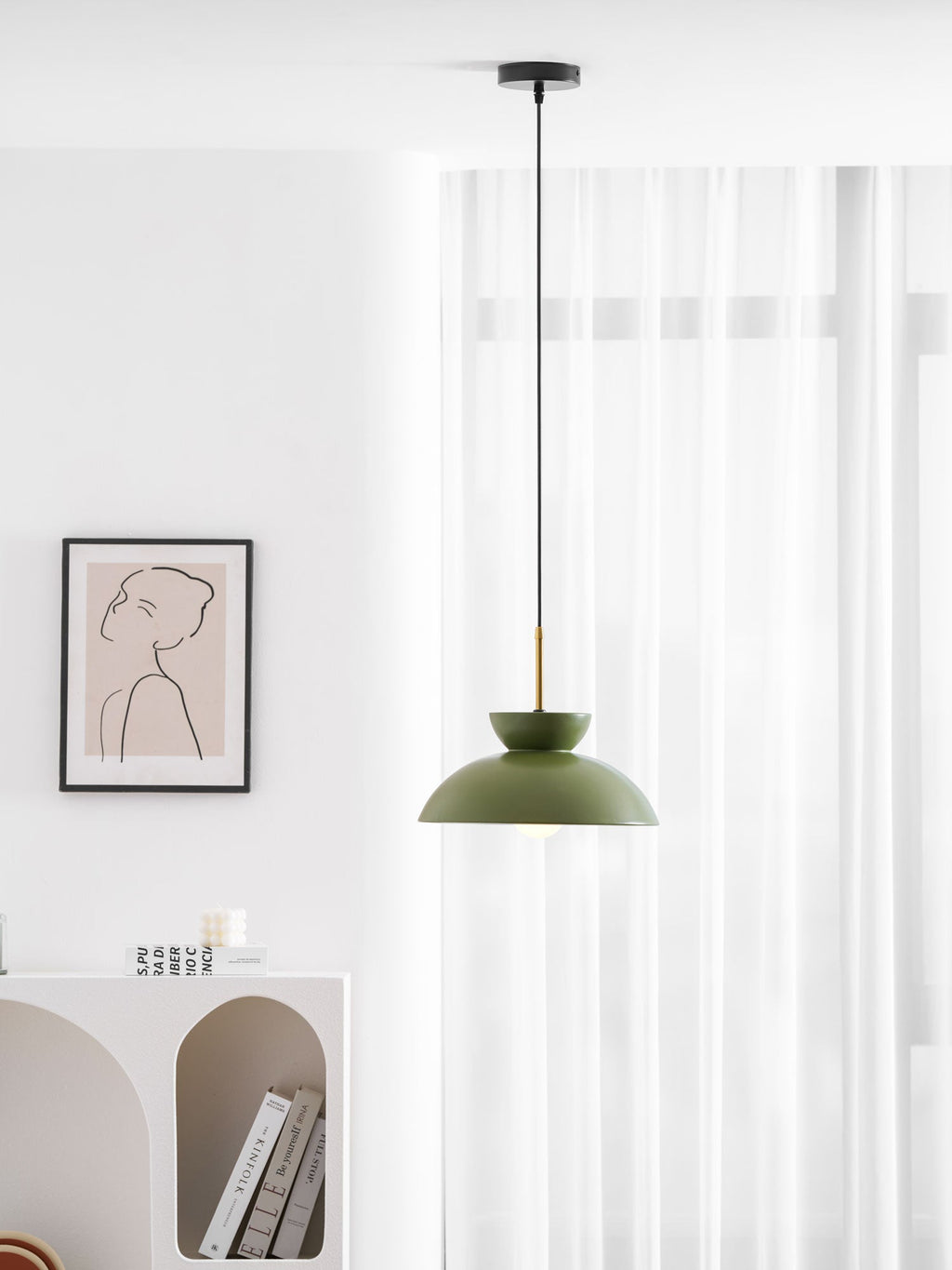 Green dome pendant from Clérachic on a black ceiling canopy, hung in a bright room beside a framed line drawing.