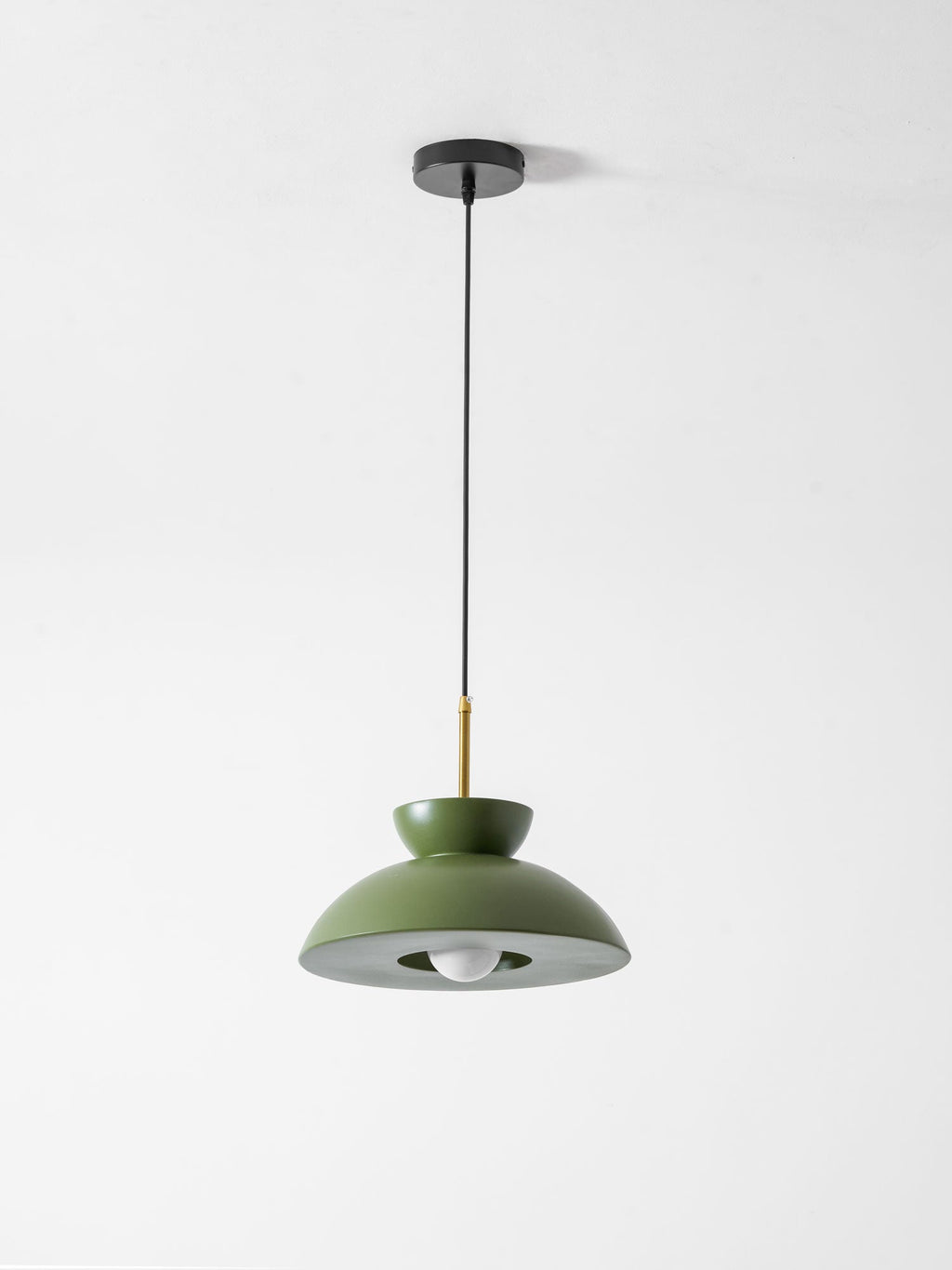 Green dome pendant on a black ceiling canopy and long cable, this Clérachic light shown against a pale backdrop.