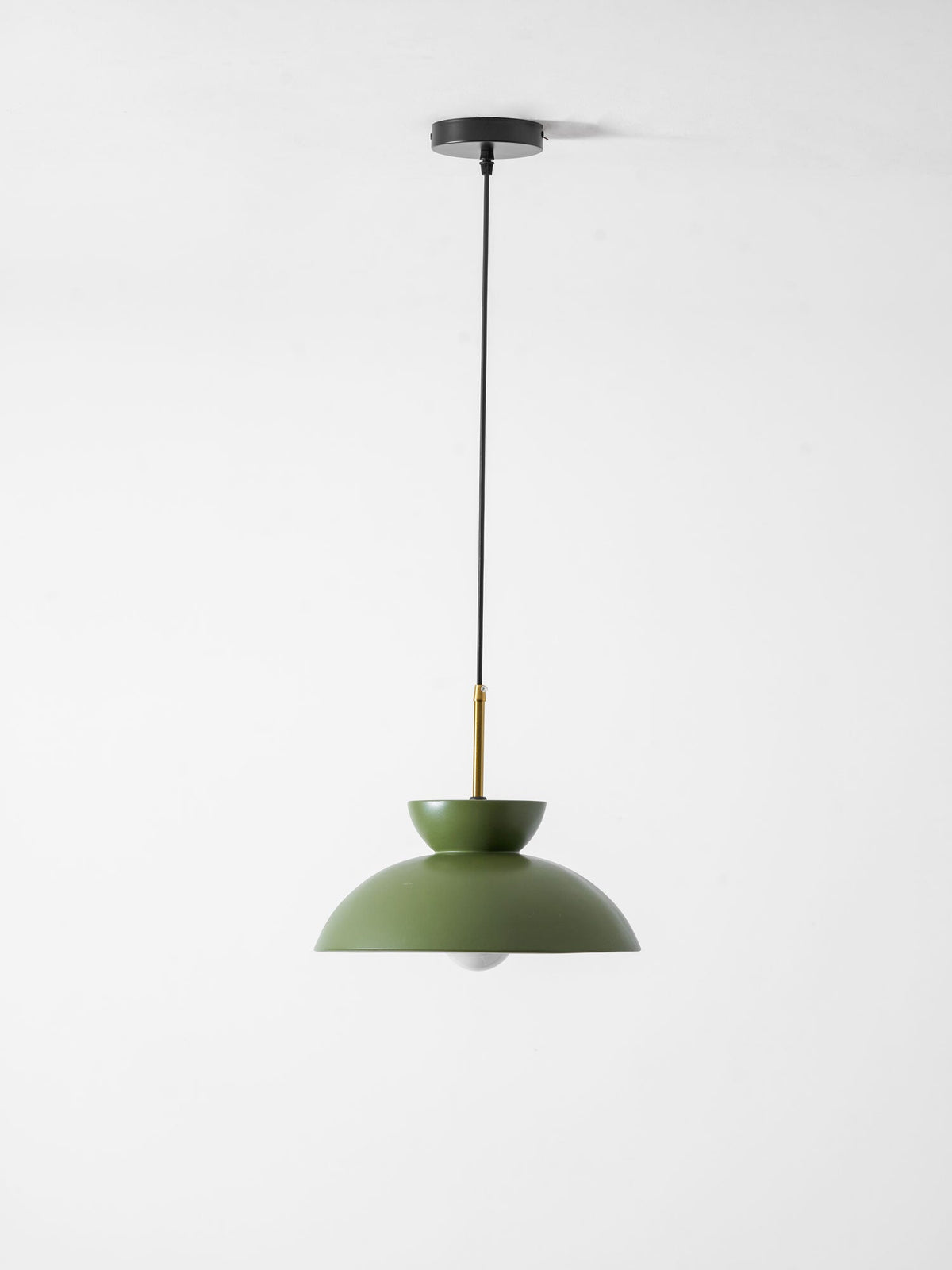 Full-length view of this green Clérachic pendant, from its black ceiling plate down to the matte dome and bulb.