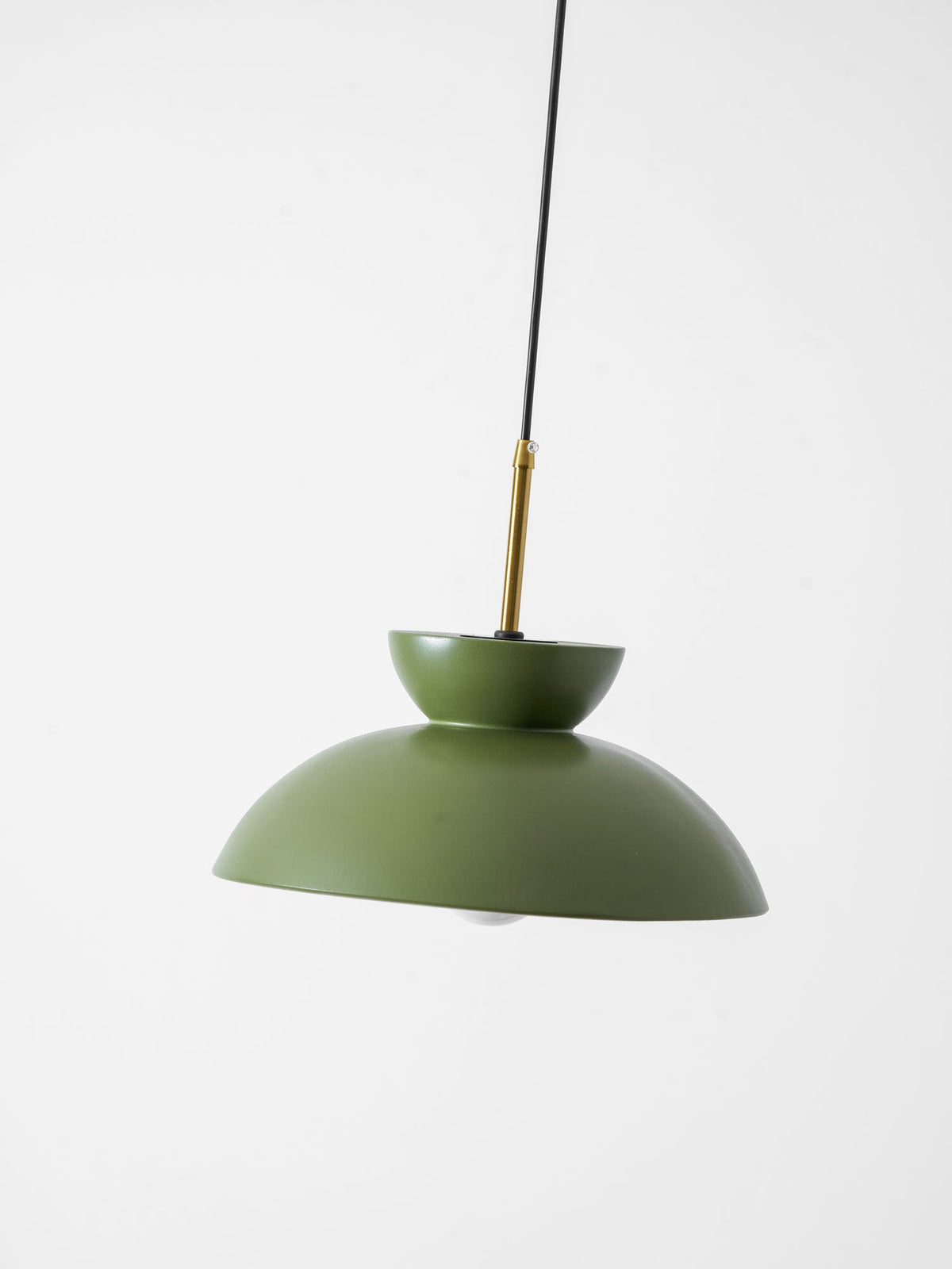 Tilted view of the green Clérachic pendant, showing the brass stem, the upturned bowl and the matte dome.