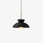 Black matte dome pendant from Clérachic with a brass stem, shown on a pale grey backdrop with the bulb just visible.