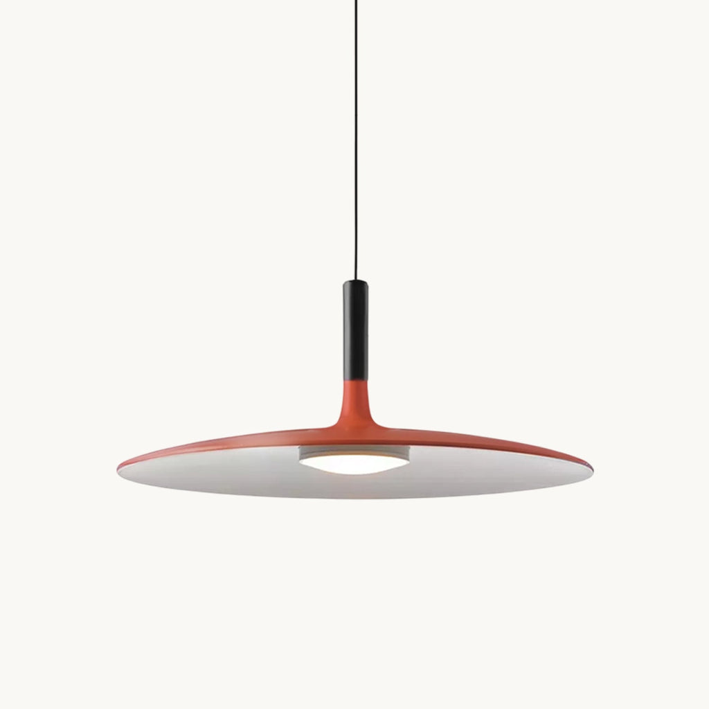 Orange Clérachic pendant light on a plain white background, its wide disc shade and black stem on a thin cord.