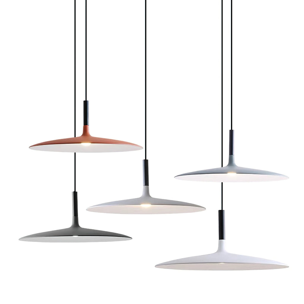 Six Clérachic pendants in orange, grey, black and white hung at different heights against a plain white backdrop.