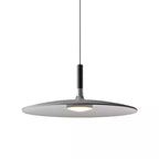 A grey Clérachic pendant on white, its disc shade tilted slightly with a black stem and round diffuser underneath.