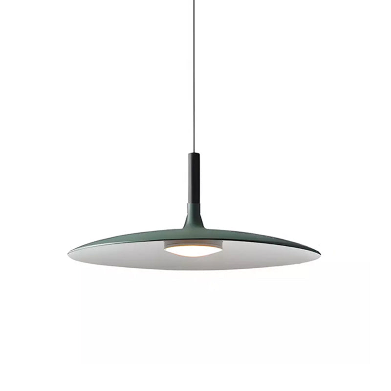 Large green Clérachic disc pendant on a white background, with a thin black cord and glowing diffuser below.