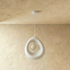 Clérachic white textured teardrop pendant with the crater-textured globe switched off inside its open ring, on a white cord.