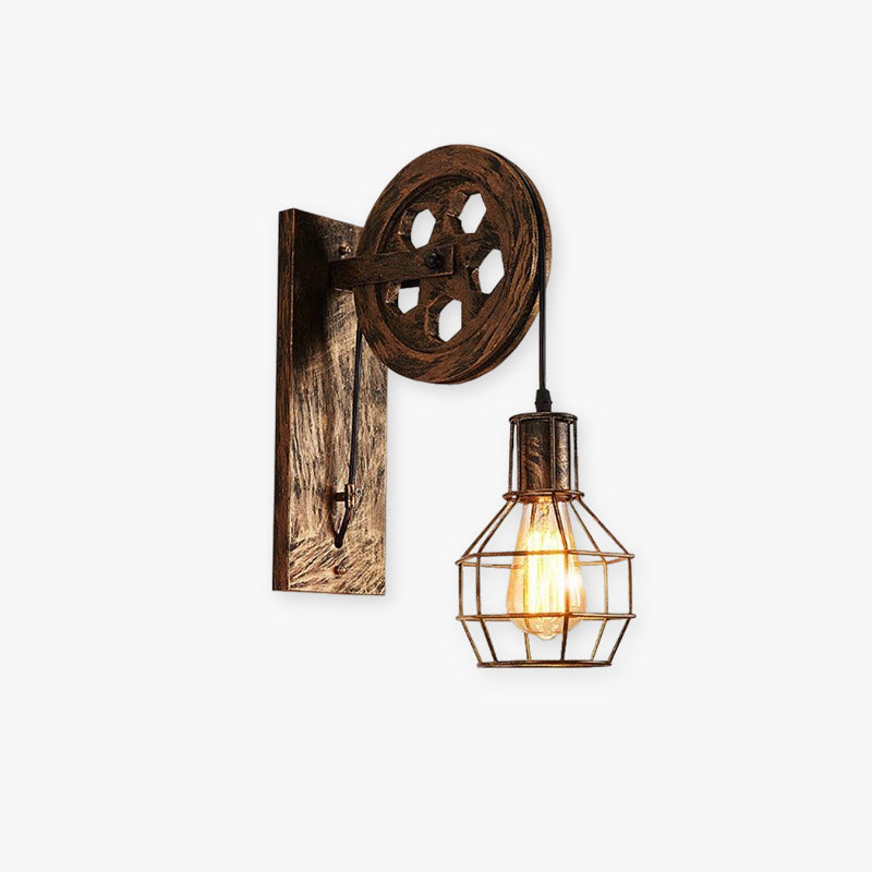 Clérachic retro pulley sconce on white, cast wheel above a caged Edison bulb on a wood plate.