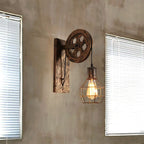 Clérachic pulley sconce on a concrete wall between two windows fitted with white blinds.