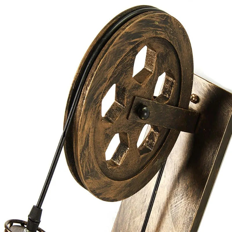 Close detail of the Clérachic pulley wheel, hexagonal cut-outs in the aged cast metal.