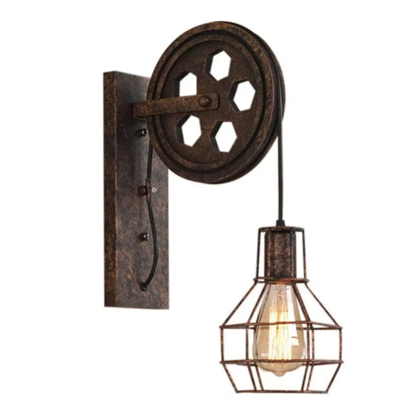 Clérachic pulley sconce photographed unlit, cage shade hanging free below the wheel.
