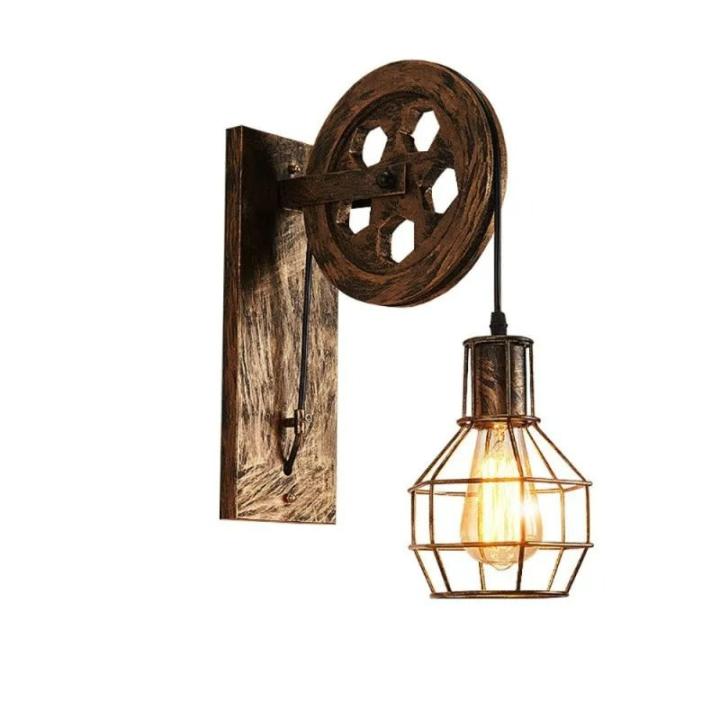 Clérachic pulley sconce angled on white, wood-grain plate and lit cage bulb in view.