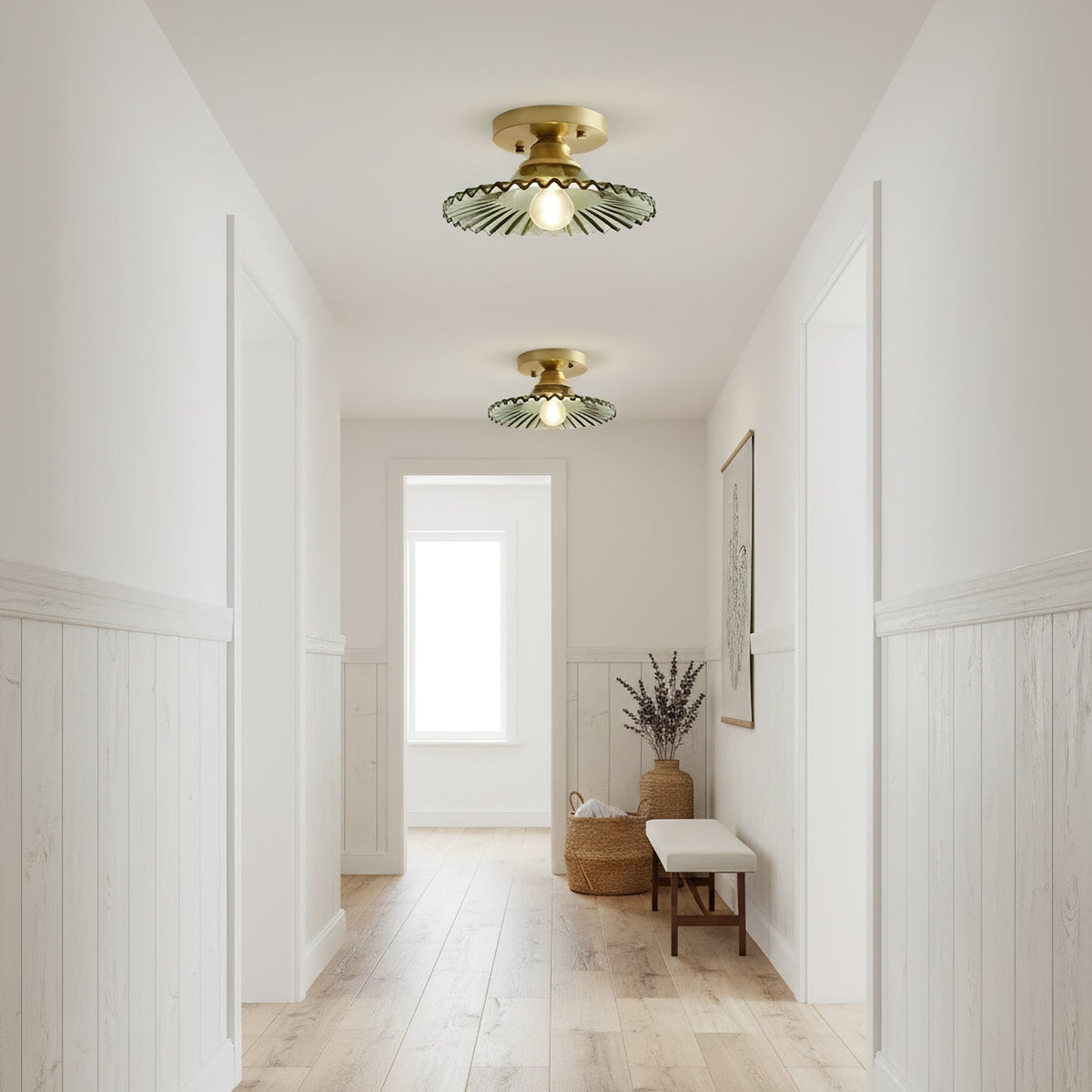 Gold-finish Clérachic ceiling lights with green glass shades, glowing down a long hallway towards a bright window and a bench.