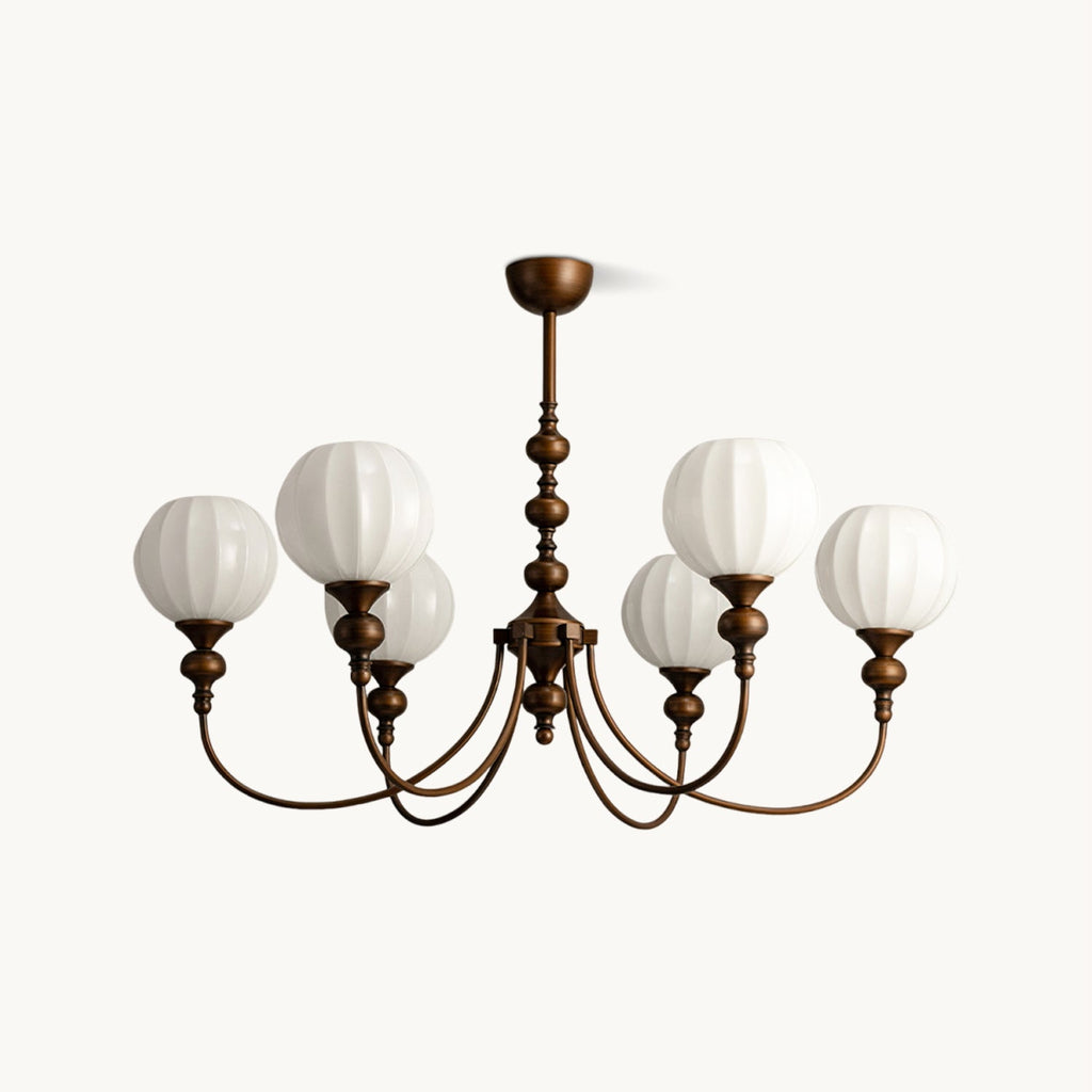 A six-light Clérachic chandelier with ribbed white glass globes on arched antique bronze arms, on a plain white backdrop.