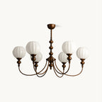A six-light Clérachic chandelier with ribbed white glass globes on arched antique bronze arms, on a plain white backdrop.