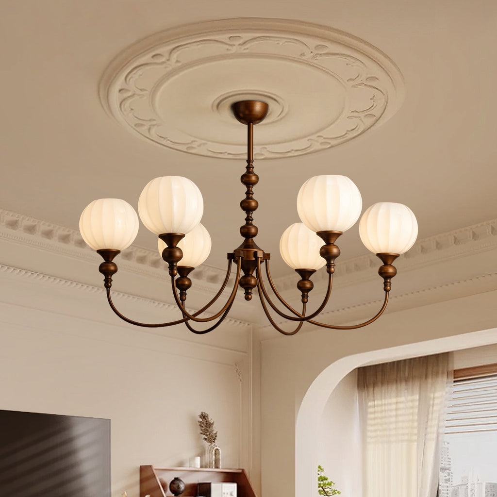 Looking up at this Clérachic chandelier and its ornate plaster ceiling rose, with six ribbed globes glowing on curved bronze arms.