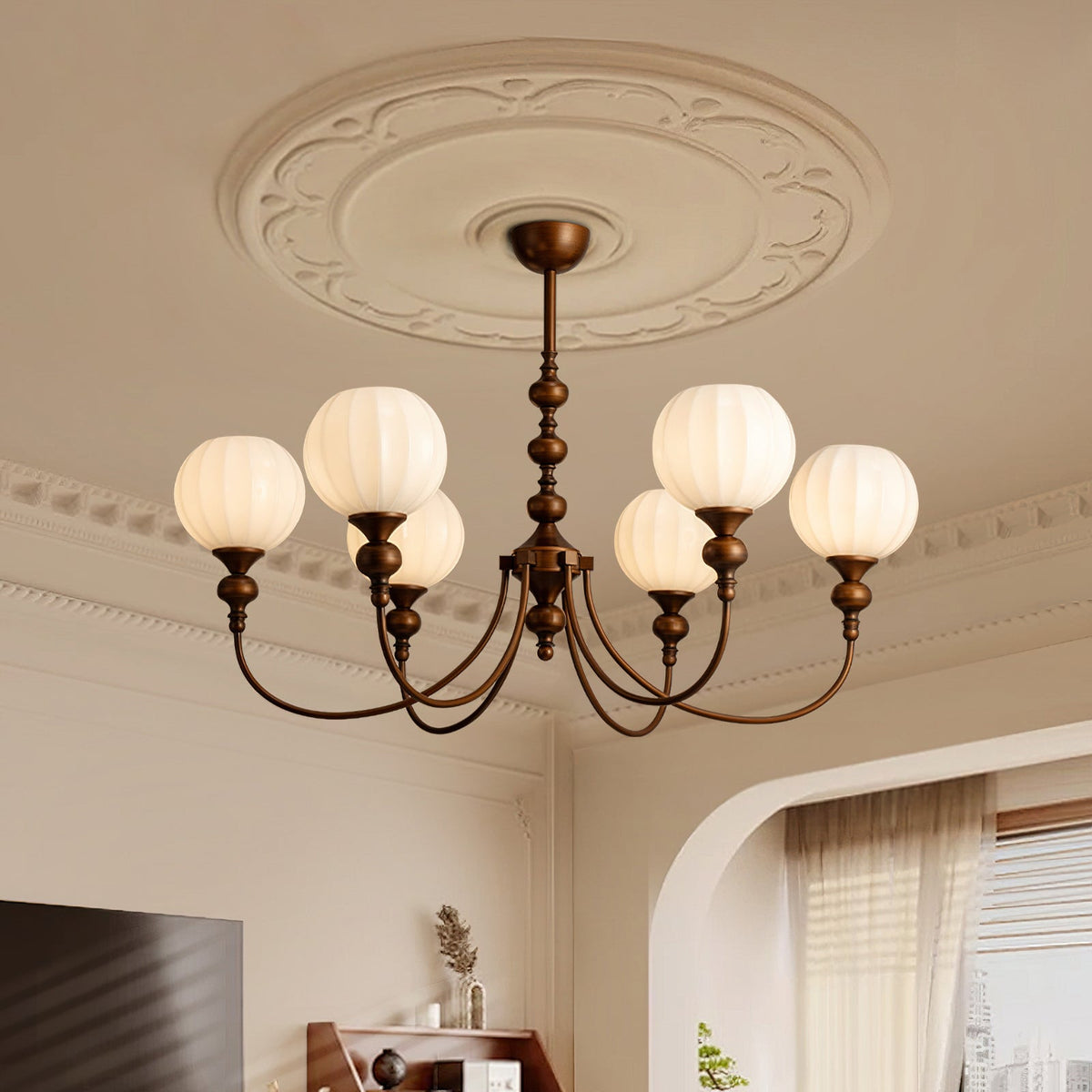 Looking up at this Clérachic chandelier and its ornate plaster ceiling rose, with six ribbed globes glowing on curved bronze arms.
