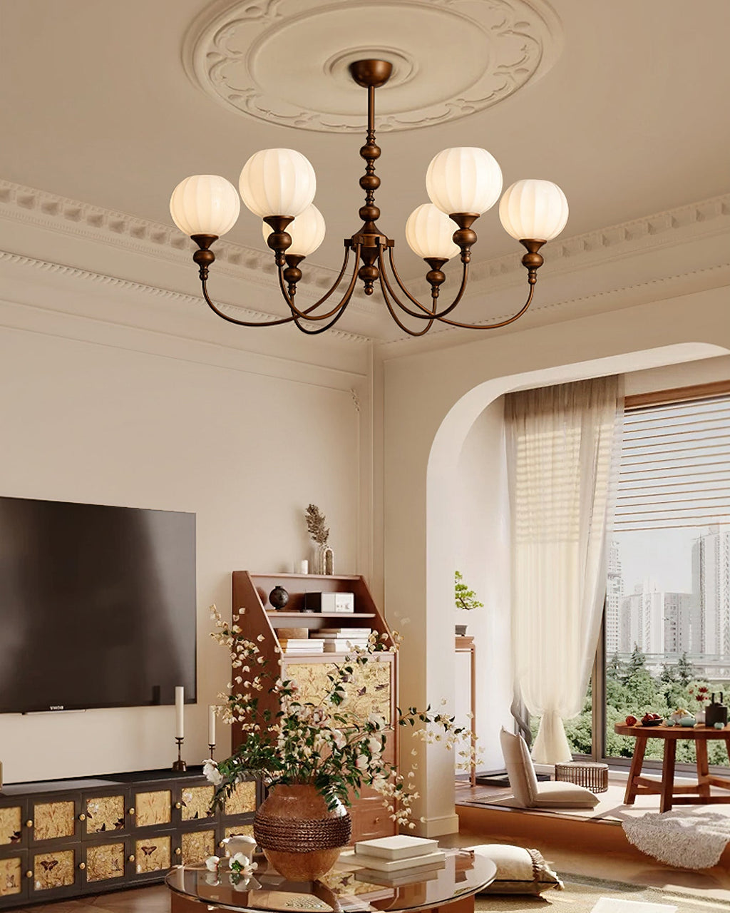 Wide view of a Clérachic chandelier with six globes in a room with an arched doorway, a wall-mounted television and a carved sideboard.