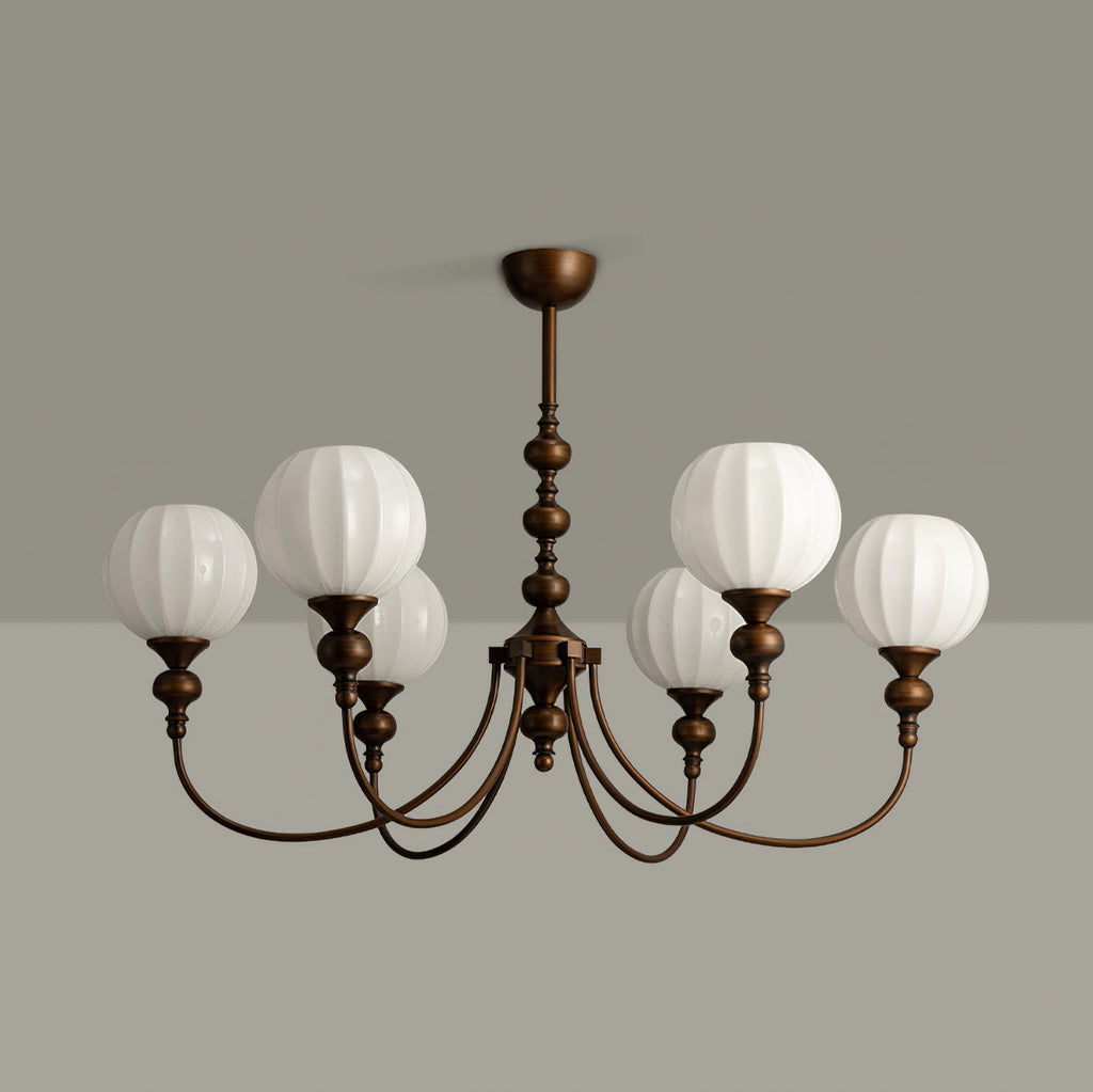 Unlit six-light Clérachic chandelier showing pale ribbed glass globes and the antique bronze arms, against a grey wall and ceiling.
