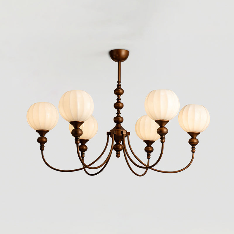 A Clérachic chandelier with six warm-glowing ribbed globes, shown from slightly below on a light grey backdrop.