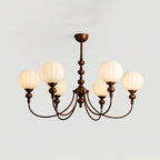 A Clérachic chandelier with six warm-glowing ribbed globes, shown from slightly below on a light grey backdrop.