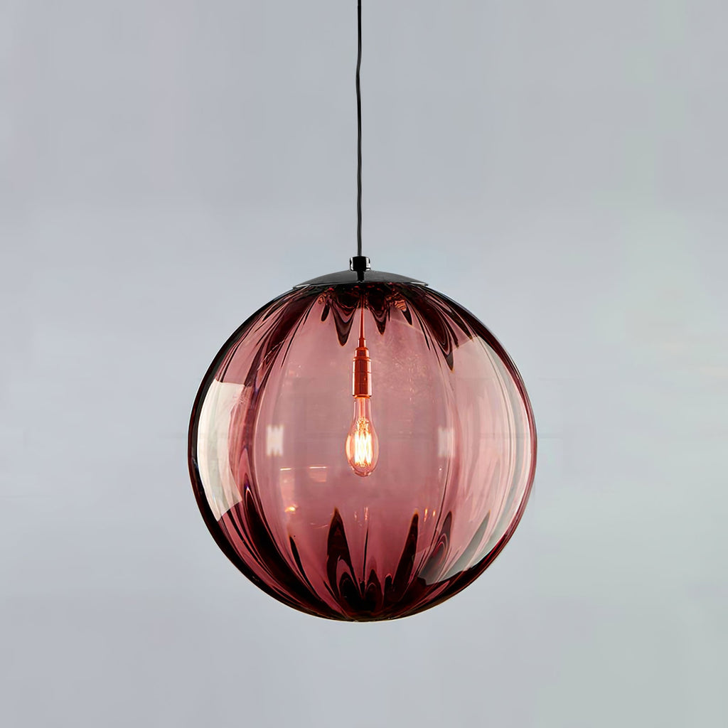 Wine red ribbed Clérachic glass pendant with a black cap, a warm bulb glowing at its centre.