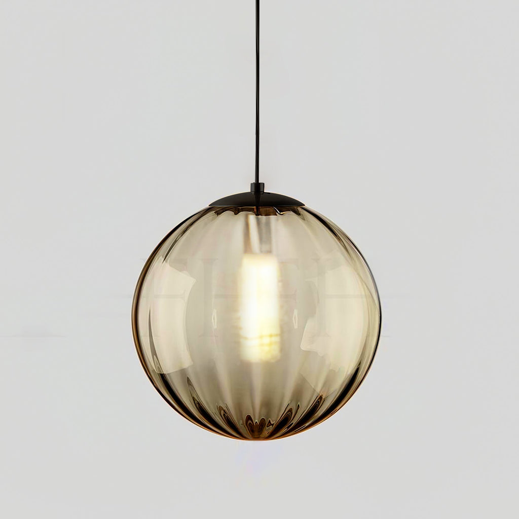Smaller amber Clérachic ribbed glass pendant with a black cap and a glowing bulb inside.