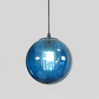 Smooth blue Clérachic glass globe pendant with a black cap, a bright bulb reflected in the glass.