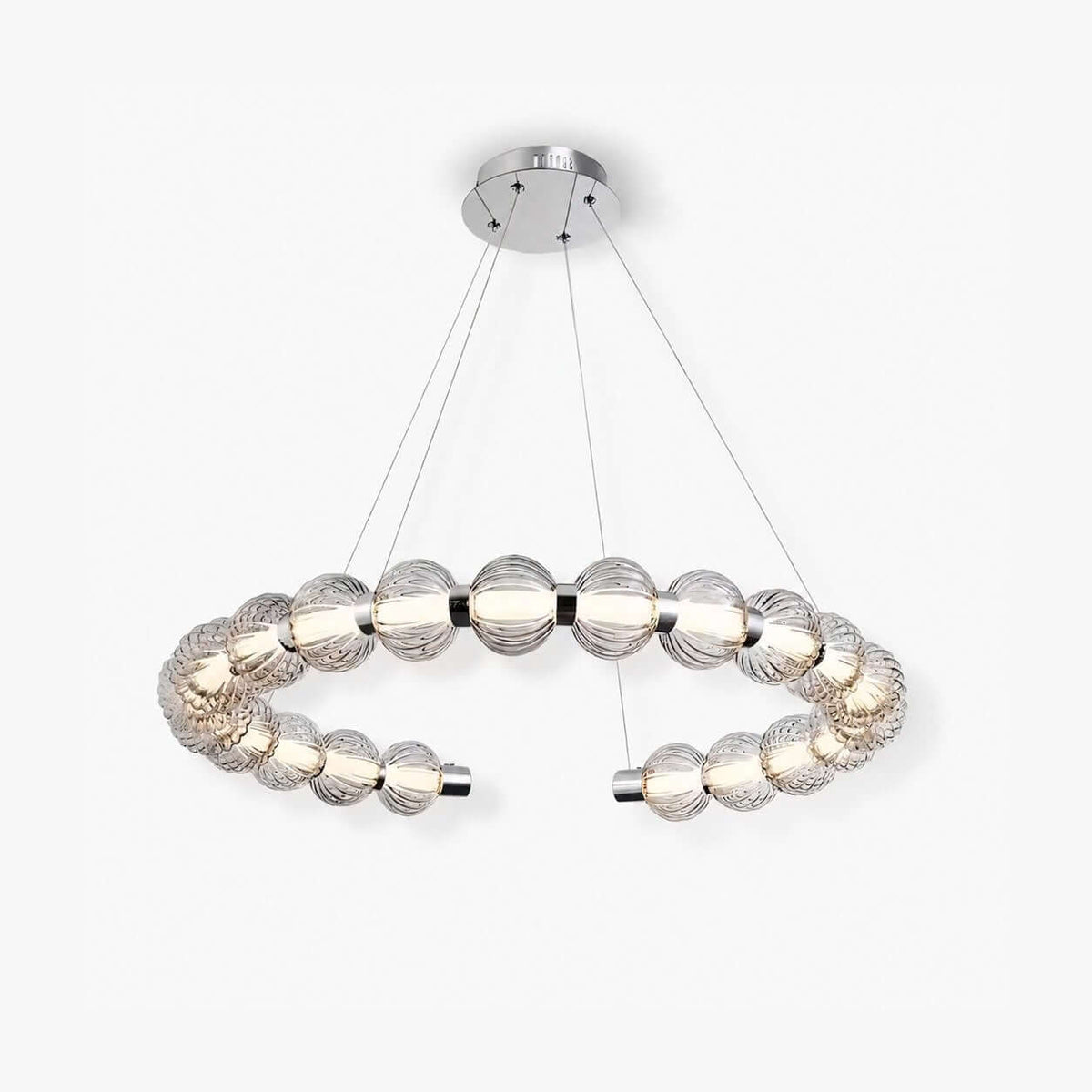 Open ring of ribbed light grey glass beads lit from within, hung on fine wires from a chrome canopy, this Clérachic pendant on white.