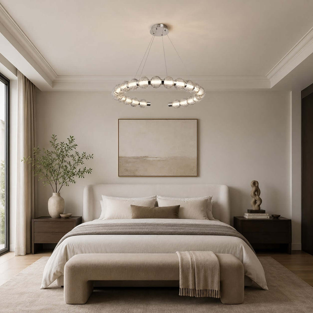 Wide view of a Clérachic pendant ring hung over a bedroom with a cream upholstered bench and an olive branch in a vase.