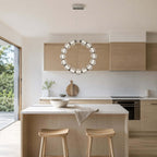 This Clérachic pendant ring hangs in front of pale wood cabinets above a light oak island with two stools.