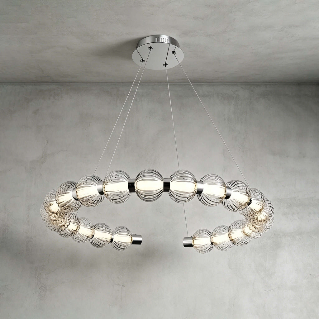 Horizontal open ring of ribbed glass beads with chrome end caps, hung from a round canopy on this Clérachic pendant.