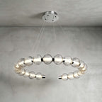 Horizontal open ring of ribbed glass beads with chrome end caps, hung from a round canopy on this Clérachic pendant.