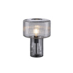 Smoky grey ribbed glass Clérachic table lamp with a black socket visible through the base, on a plain white backdrop.
