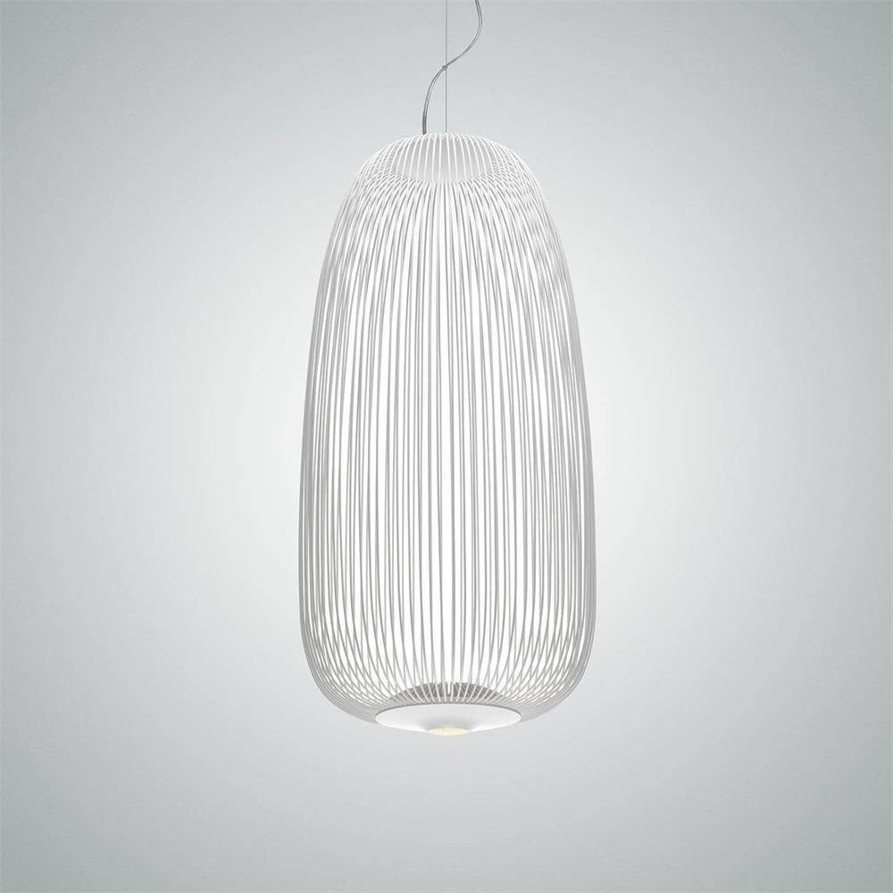 The tall oval wire-cage Clérachic pendant in white, lit on a pale grey-blue backdrop.