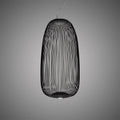 The tall oval wire-cage Clérachic pendant in black, with its fine wires and a lit base against a grey backdrop.
