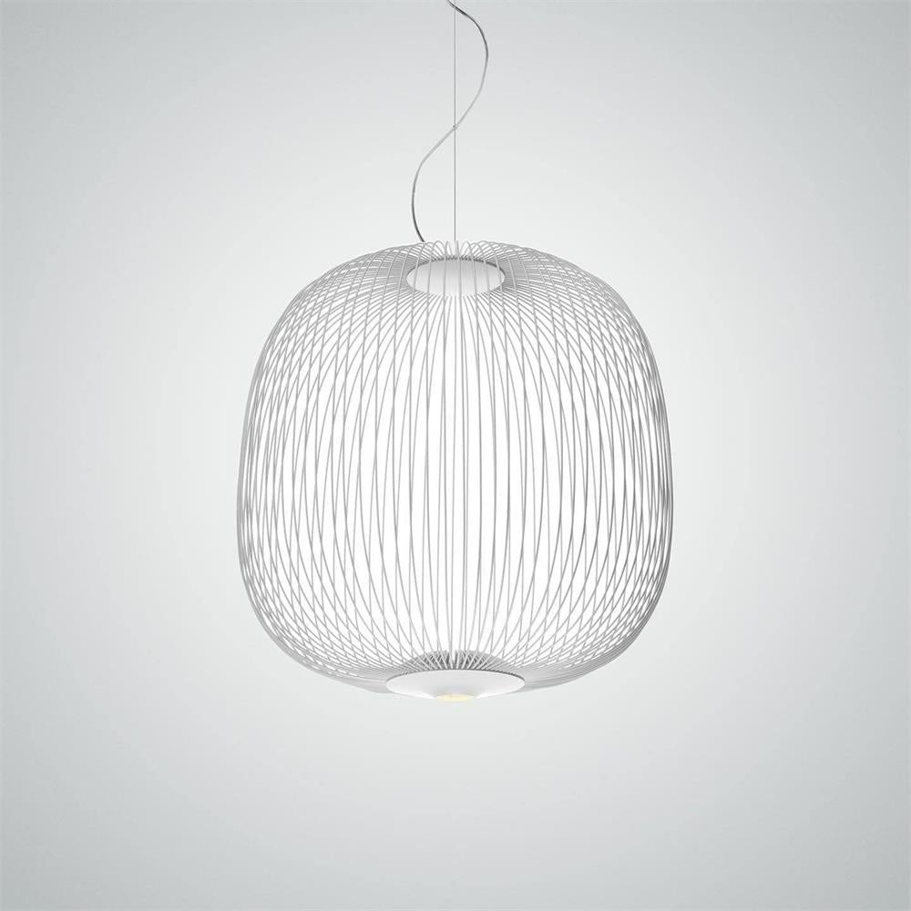 The wide, rounded wire-cage Clérachic pendant in white on a pale grey backdrop, its lit base visible below.