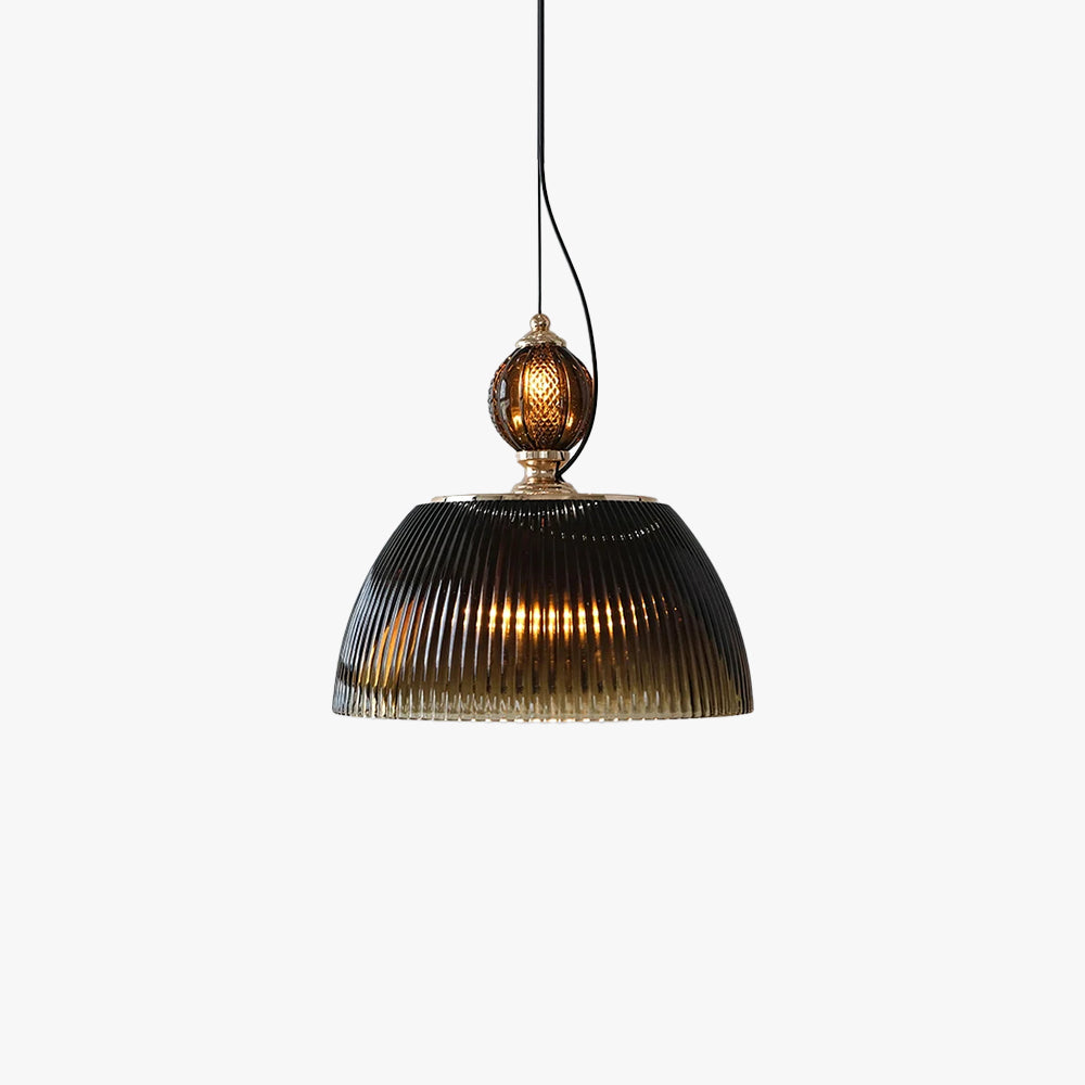 Studio view of the Clérachic ribbed smoked-glass pendant light, showing the brass collar and dome lit warmly from within.