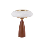This Clérachic ribbed table lamp with a white shade on a white backdrop, a brass top over a tapered walnut-colour base.