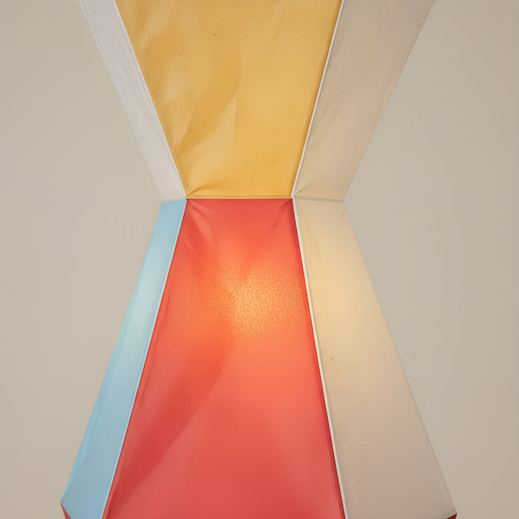 Close view of the point where two modules meet, showing the hand-folded rice paper, its crisp folded ridges and the brush marks in the painted facets