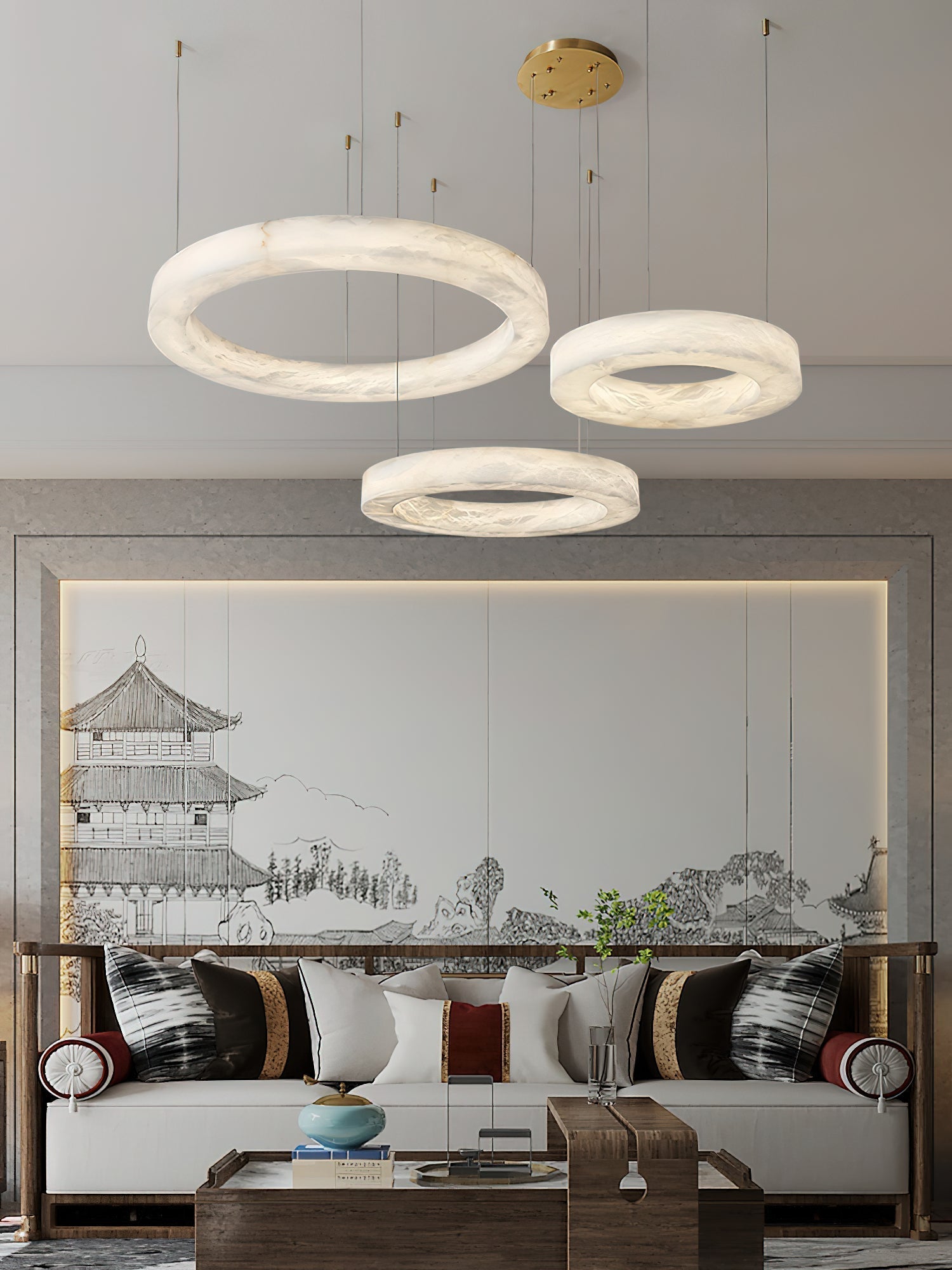 The Clérachic three-ring chandelier above a seating group, hoops staggered in front of a painted screen.