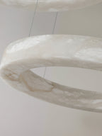 Close detail of the Clérachic alabaster ring, the stone's translucent grey veining lit from inside.