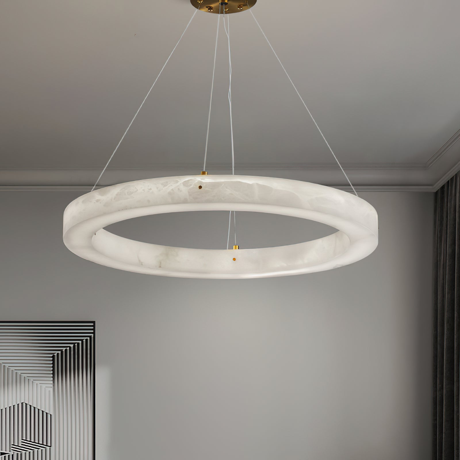 The Clérachic chandelier hung from a brass canopy in a soft grey room, the alabaster ring lit end to end.