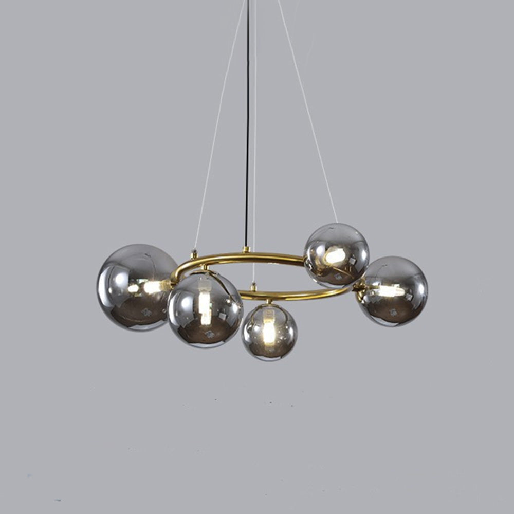Studio view of the brass Clérachic ring-frame pendant fitted with 5 smoked mirrored glass globes on a gray backdrop.