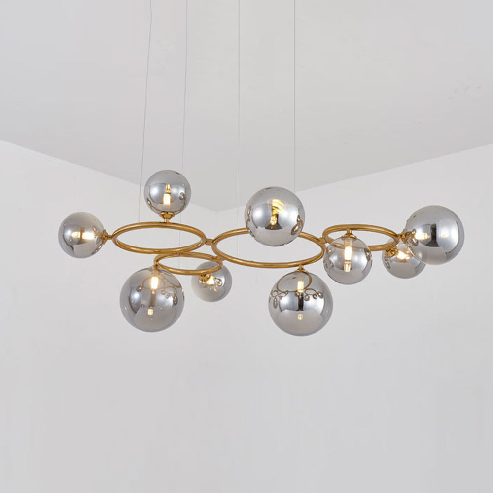 The brass Clérachic ring-frame pendant carries 9 smoked mirrored glass globes across its double ring frame.