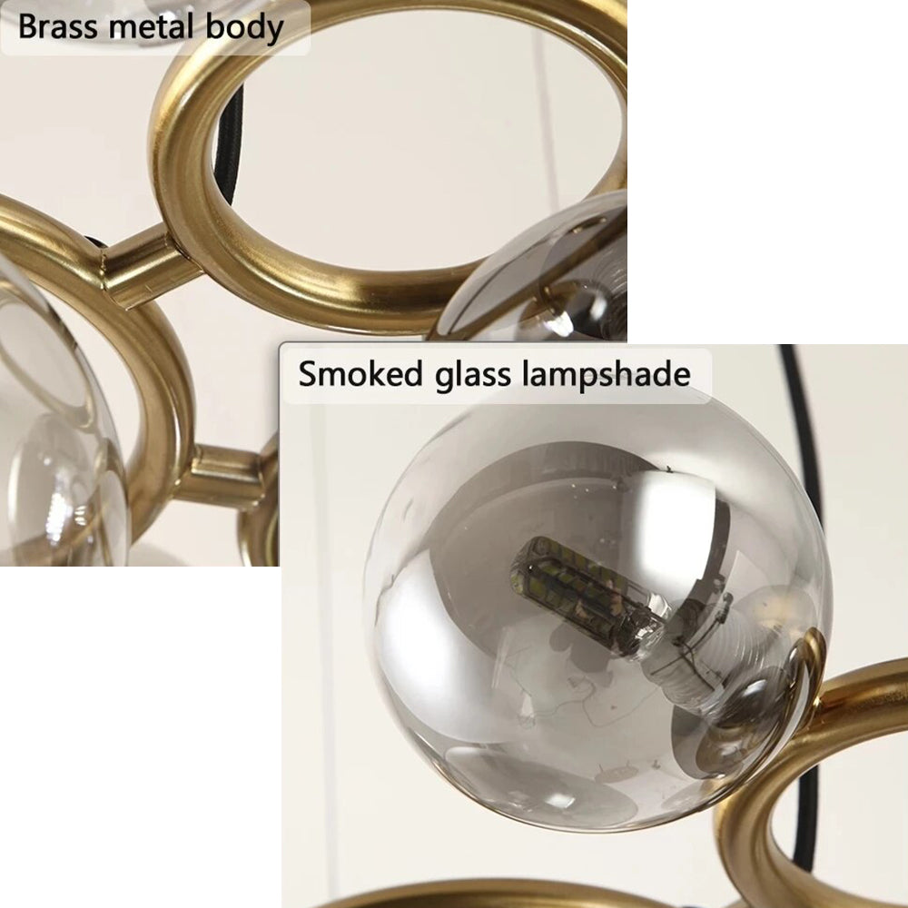 Detail shot of the Clérachic ring-frame pendant labelling its brass metal ring body and smoked glass lampshade with a G9 LED bulb.