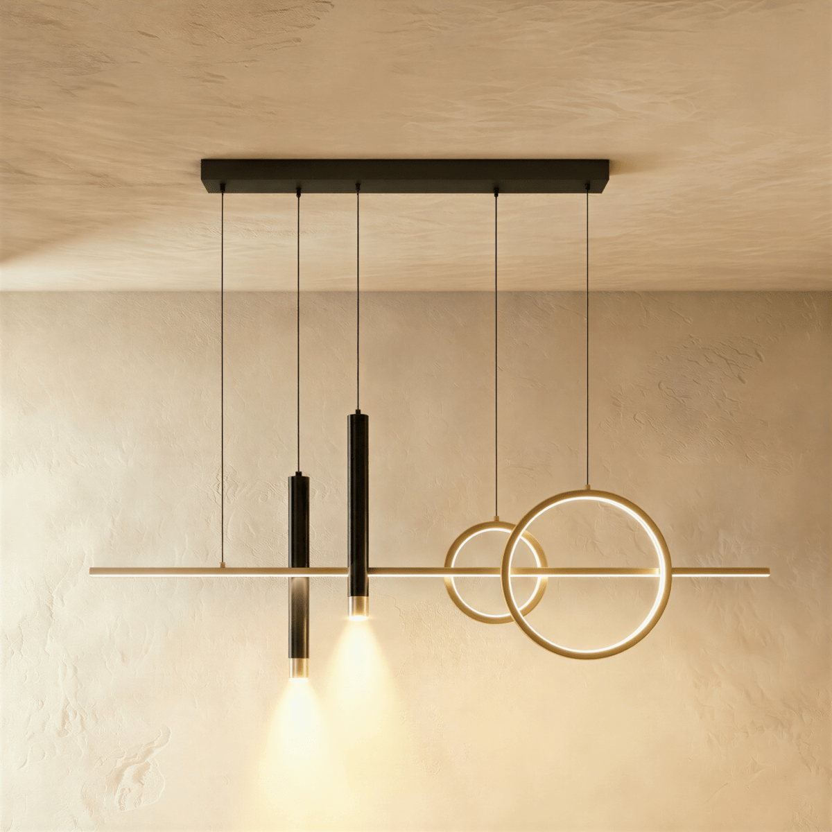 Clérachic gold and black pendant light with a linear bar, two rings and two spotlight cylinders glowing on a limewash wall.
