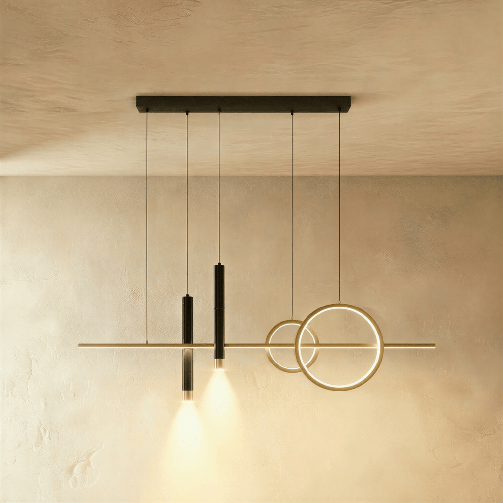 Clérachic pendant light with a gold bar and rings and two black spot cylinders hanging from a black canopy bar.