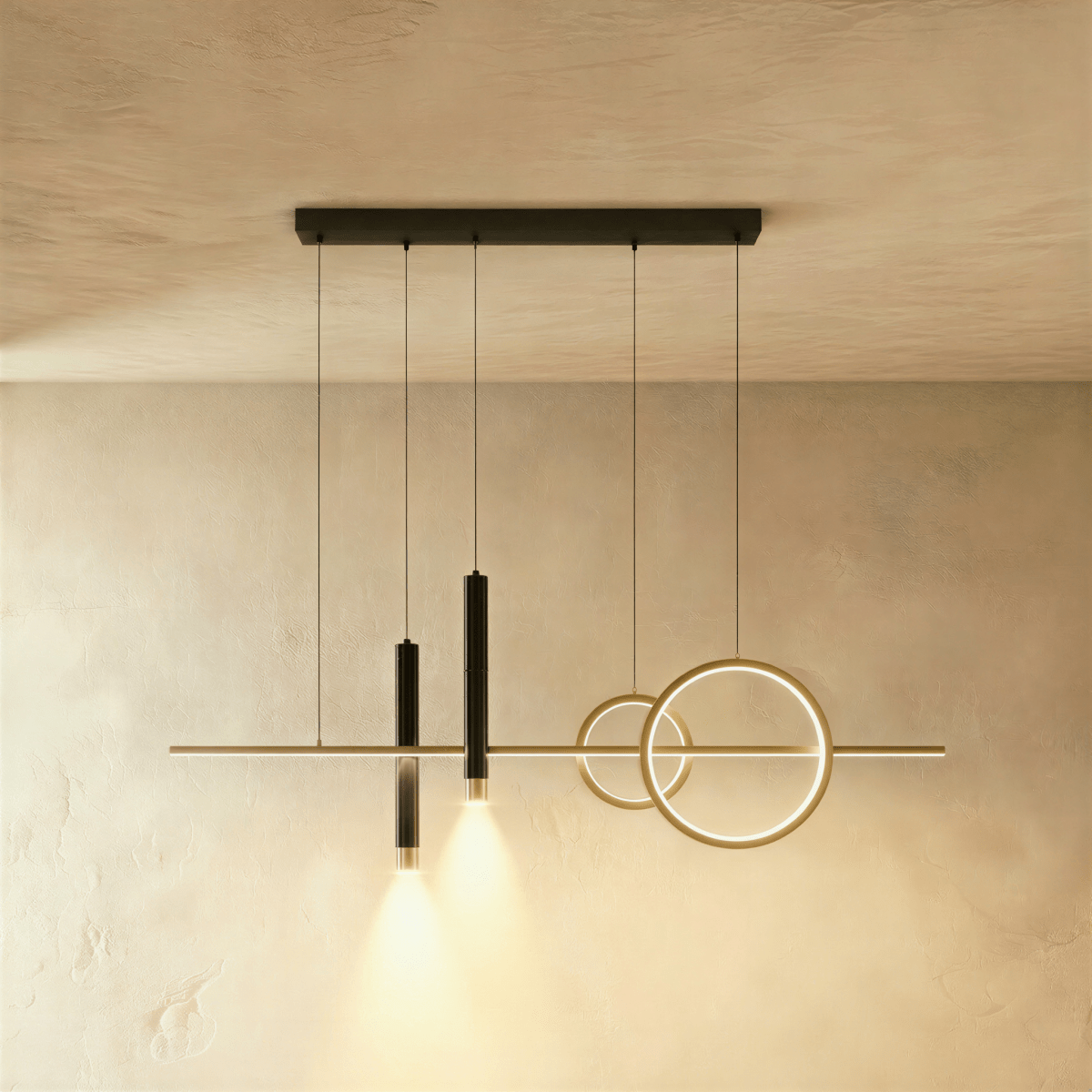 Clérachic pendant light with a gold bar and rings and two black spot cylinders hanging from a black canopy bar.